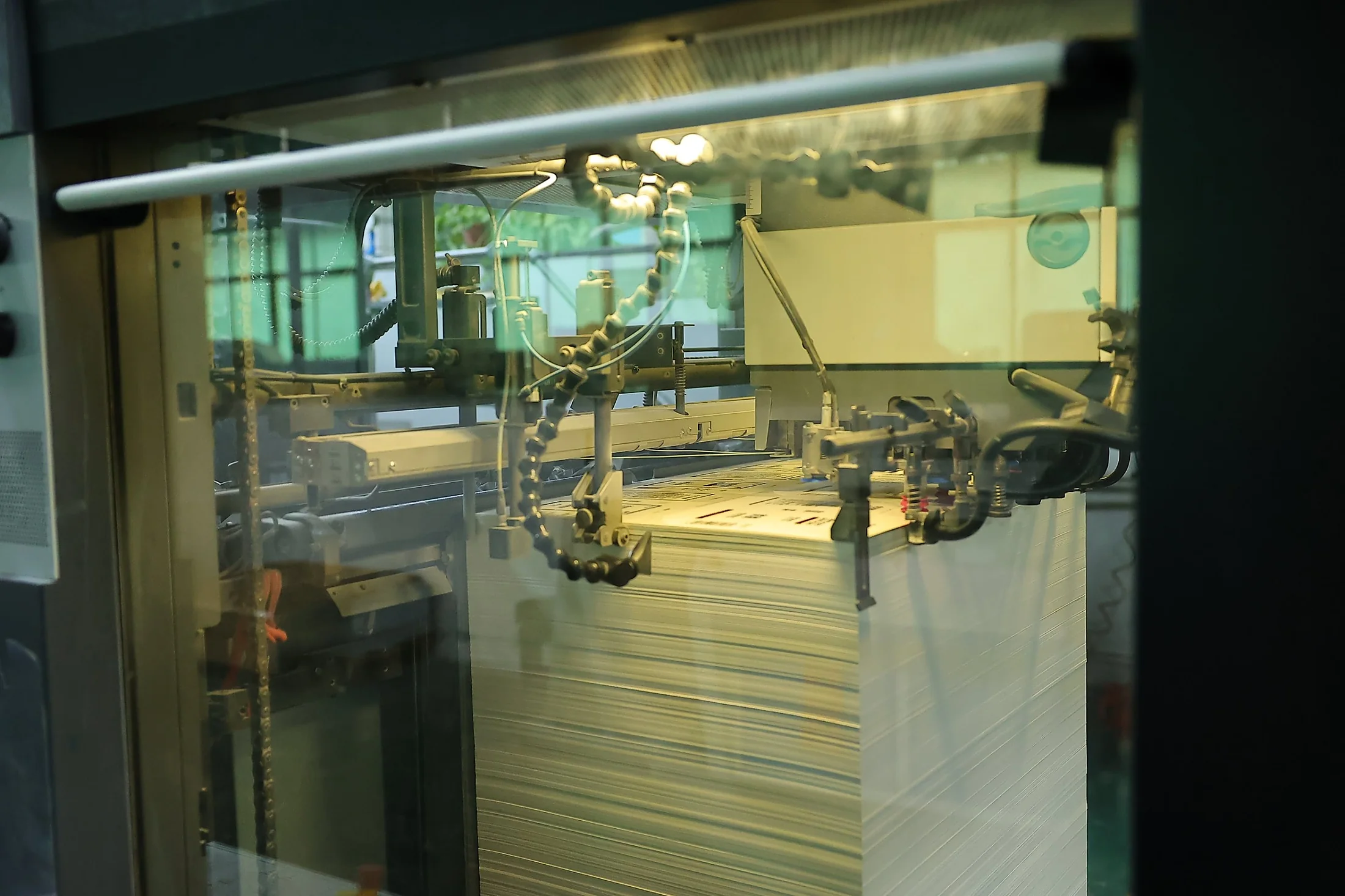 Sheet feeder of a carton printing press with a stack of printed board
