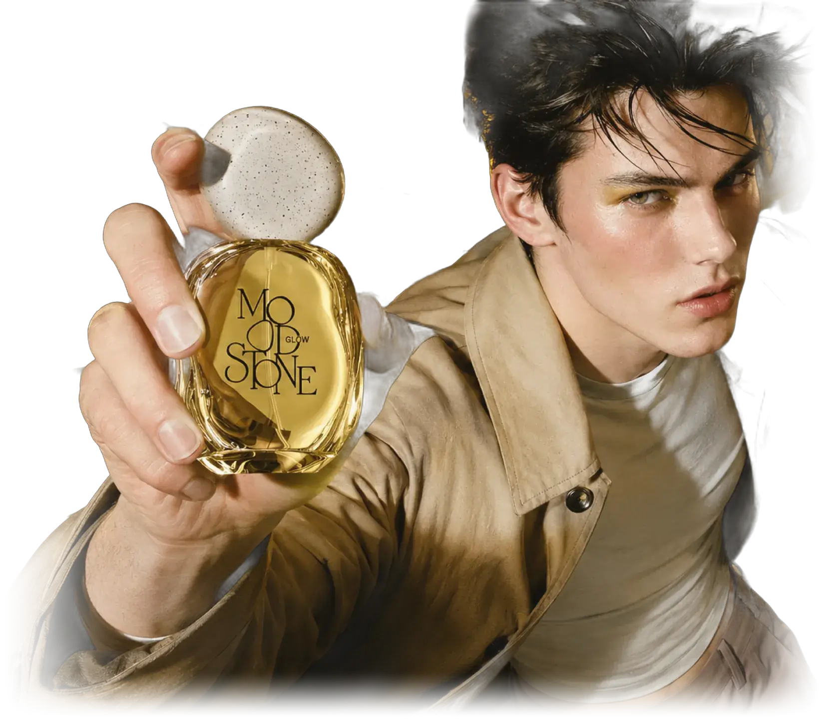 The GLOW model in a beige trench coat holding the amber MOOD//STONE bottle out toward the camera