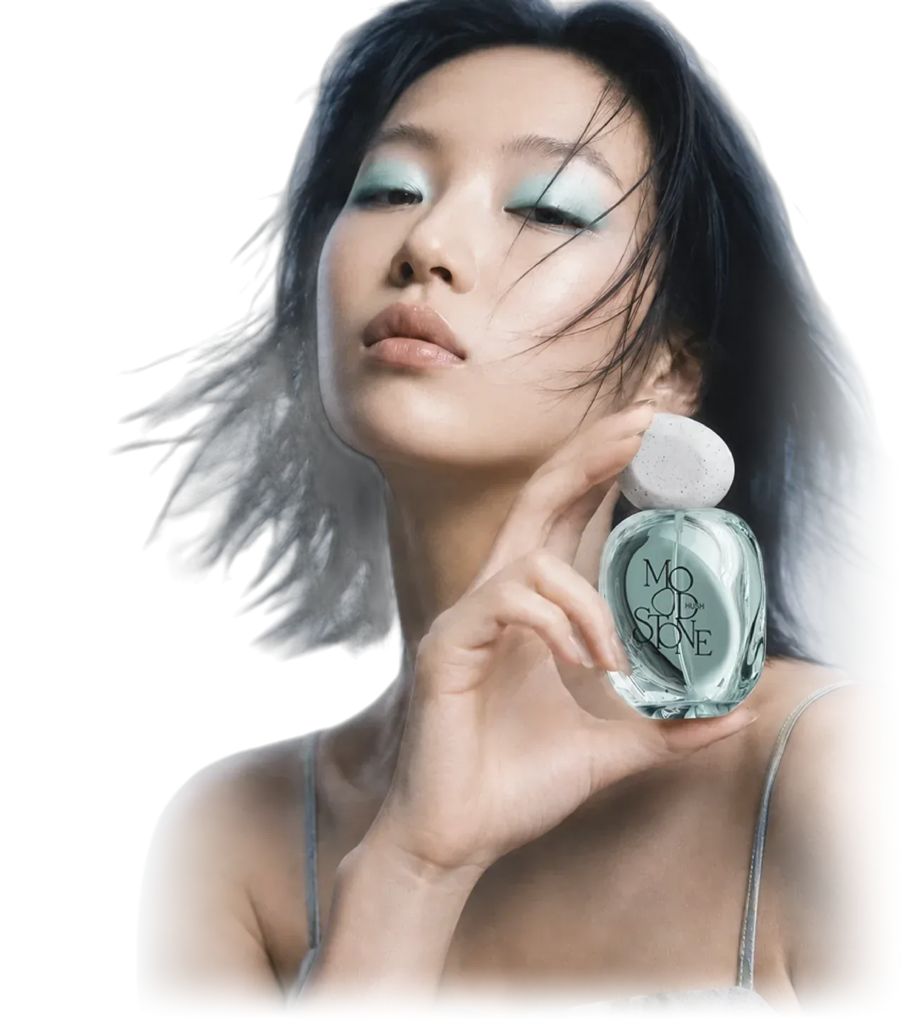 The HUSH model with aqua eye shadow holding the pale blue MOOD//STONE bottle beside her face