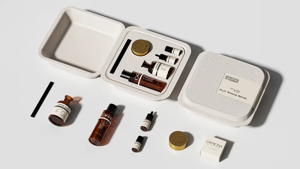 OFFICINA gift set: a molded-pulp case with mist bottle, reed diffuser, dropper, mini vial and solid perfume tin laid out beside it.