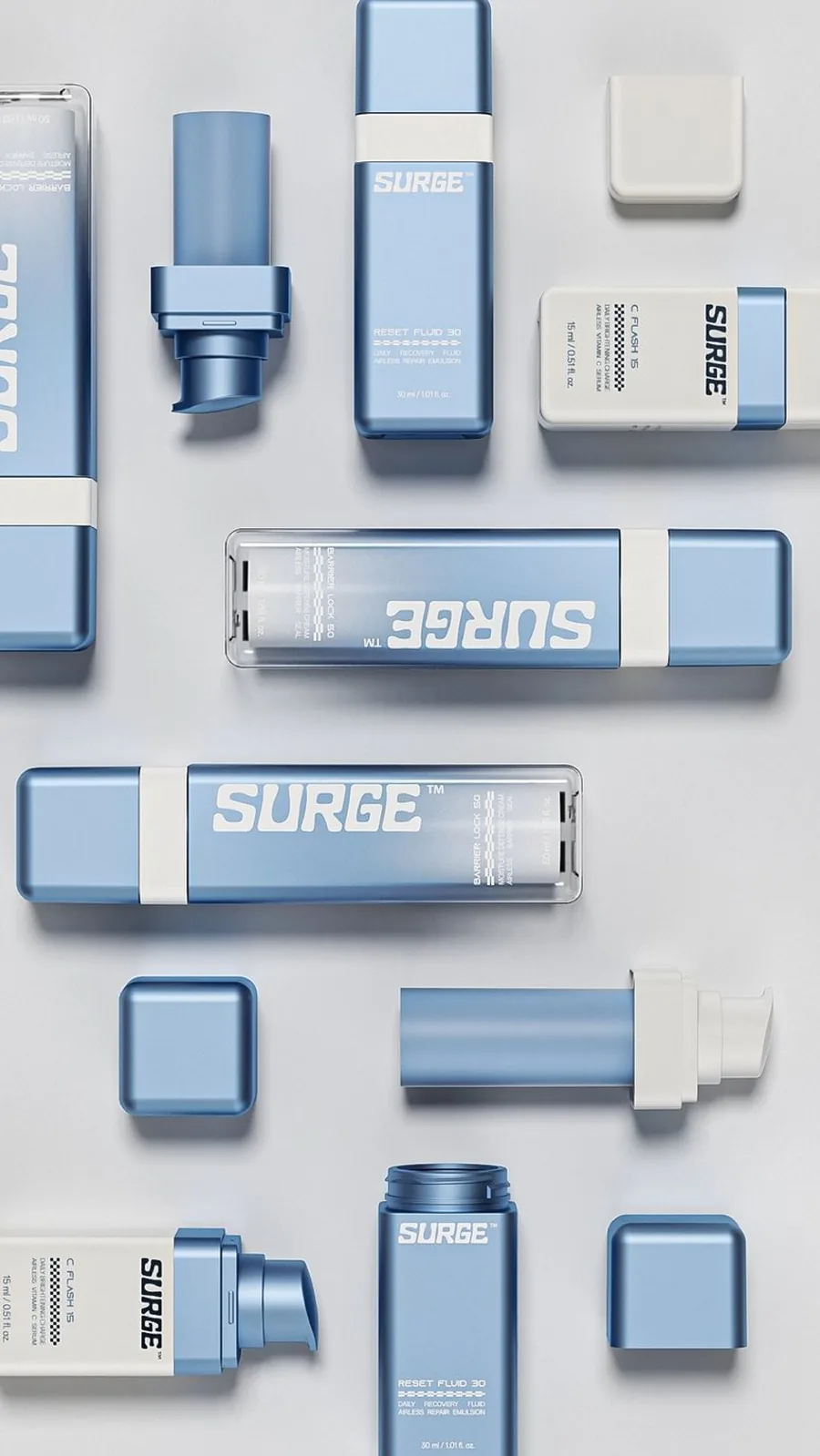 SURGE skincare collection in blue and white airless bottles, refills and caps arranged as a flat lay.